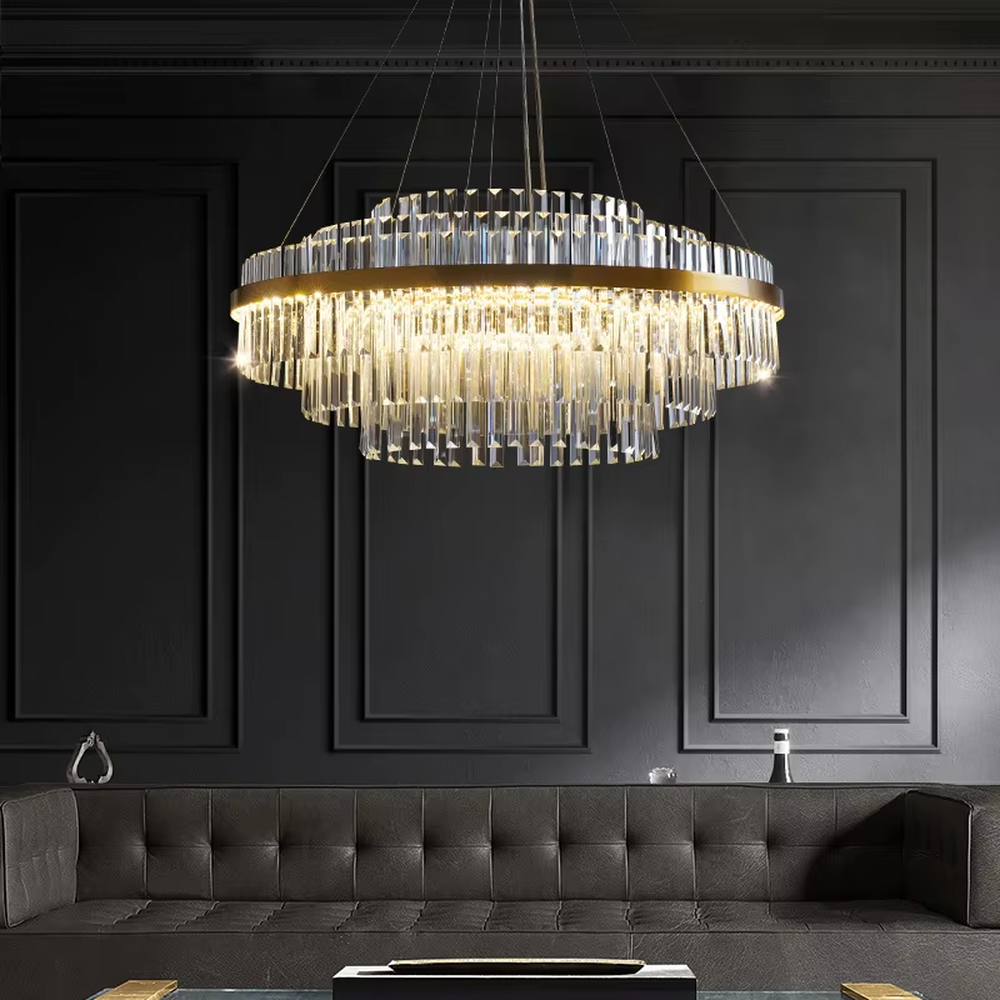 A modern light luxury style circular double-layer crystal chandelier, featuring a gold metal frame paired with multiple layers of long cut crystal strips. It emits a brilliant and soft glow when lit, combining decorative appeal with practical illumination, ideal for creating a luxurious and high-end space atmosphere.