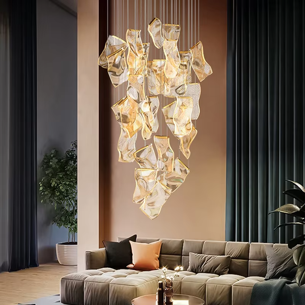 A modern light luxury style layered art chandelier, featuring irregularly folded transparent glass panels suspended by thin wires, with gold trim on the edges. It emits a soft and transparent glow when lit, combining decorative appeal with practical illumination, ideal for creating a high-end and dreamy space atmosphere.
