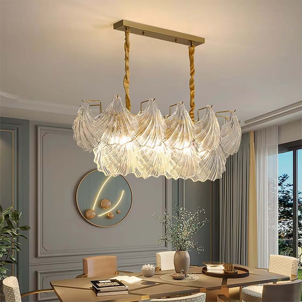 A modern light luxury style art chandelier, featuring a gold metal frame paired with multi-layered fan-shaped textured transparent glass panels, shaped like overlapping ginkgo leaves in bloom. It emits a soft and brilliant glow when lit, combining decorative appeal with practical illumination, ideal for creating a romantic and elegant space atmosphere.
