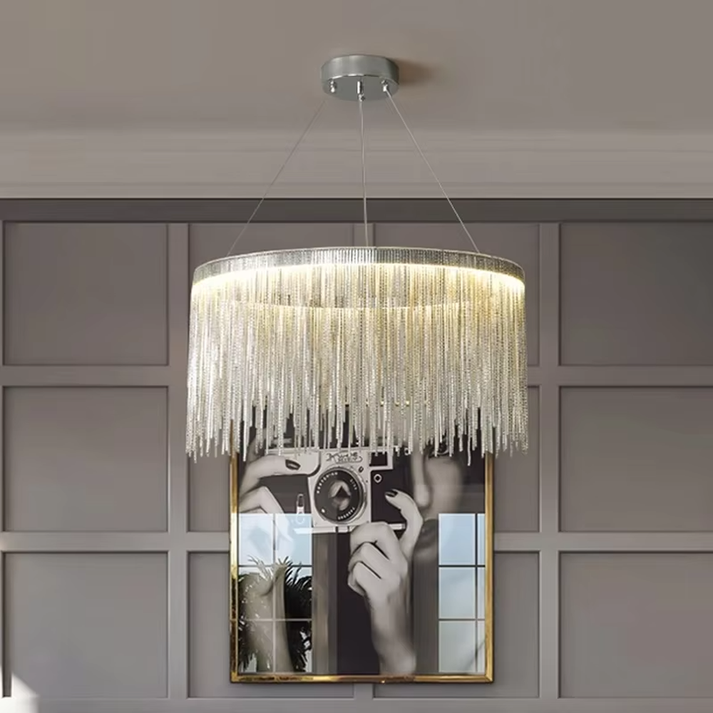 Light luxury metal tassel chandelier, crafted with copper-gold metal strips to create a cascading tassel shape. Light passes through the metal strips to produce a warm, layered lighting effect, making it a high-end decorative lighting fixture that combines artistry and ambiance.