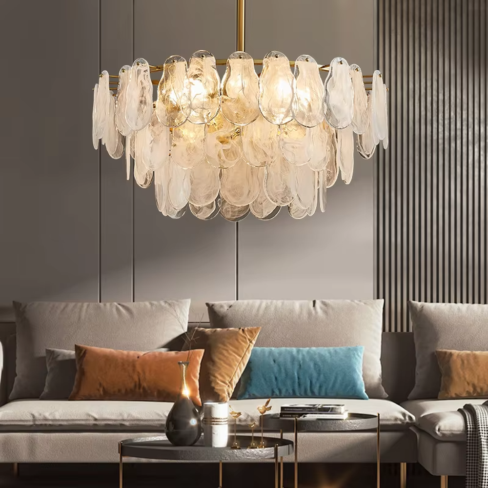 A modern light luxury style ring chandelier, featuring a gold metal frame with layered gradient glass petal panels. It emits a soft and warm glow when lit, combining decorative appeal with practical illumination, ideal for creating an elegant and sophisticated space atmosphere.