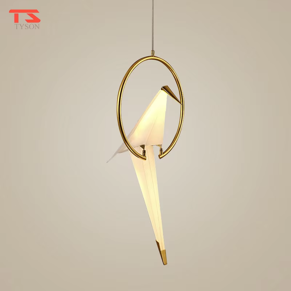 A modern art light luxury style origami crane chandelier, featuring a gold metal ring frame paired with an origami-style white translucent lampshade, shaped like an origami crane perched in a gold ring. It emits a soft and warm glow when lit, combining decorative appeal with practical illumination, ideal for creating an elegant and soothing space atmosphere.