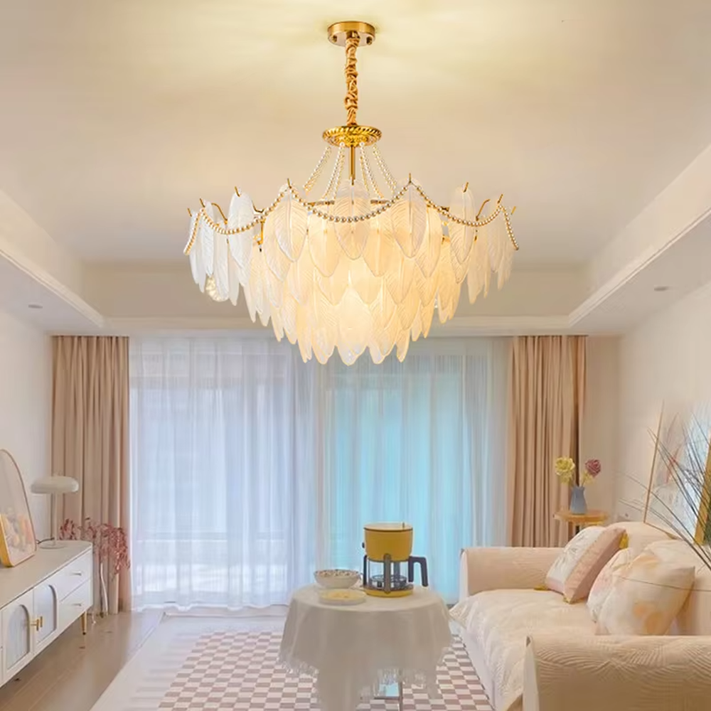 A French light luxury style feather glass chandelier, featuring a gold metal frame paired with double-layer feather-textured glass panels and pearl chain decorations. It emits a soft and warm glow when lit, combining decorative appeal with practical illumination, ideal for creating a romantic and elegant space atmosphere.