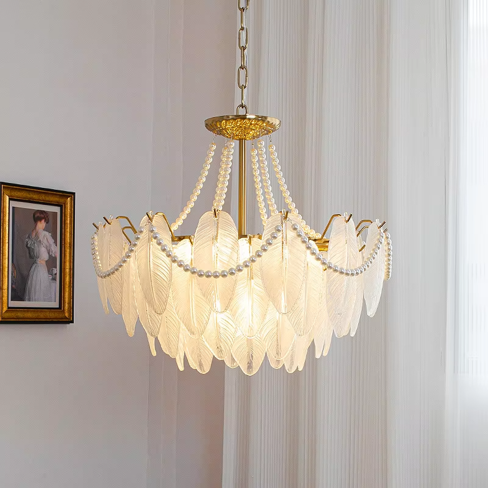 A French light luxury style feather glass chandelier, featuring a gold metal frame paired with double-layer feather-textured glass panels and pearl chain decorations. It emits a soft and warm glow when lit, combining decorative appeal with practical illumination, ideal for creating a romantic and elegant space atmosphere.