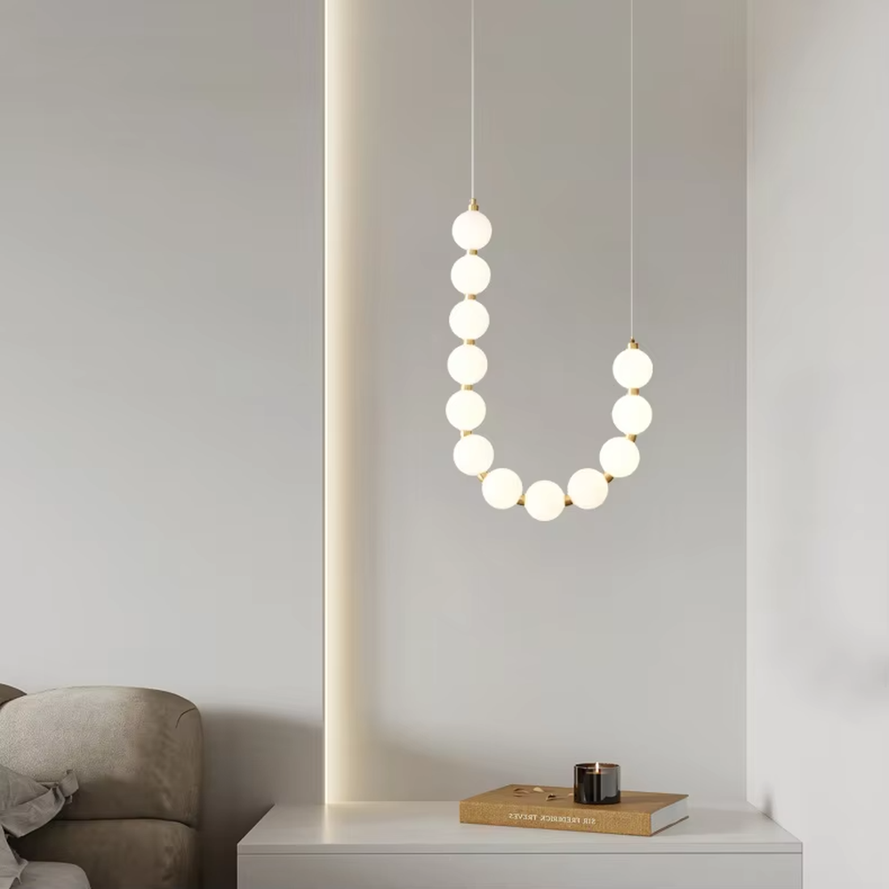Modern Light Luxury Curved Beaded Chandelier, Milk white spherical lamps connected in a wave shape with gold metal details, serves both lighting and decorative purposes, ideal for duplex stairwells, high-ceiling living rooms, villas and other high-ceiling spaces.
