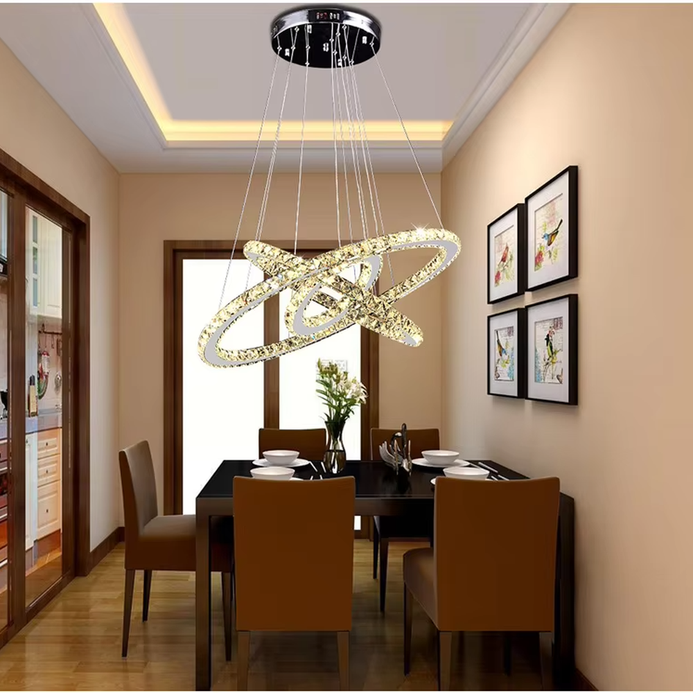 This light luxury black-gold interlaced ring crystal chandelier features a multi-layer flowing ring shape made of metal frames and crystal strips, with light refracting a brilliant halo through the crystals, serving both lighting and decorative purposes, suitable for modern light luxury spaces such as living rooms and dining rooms.