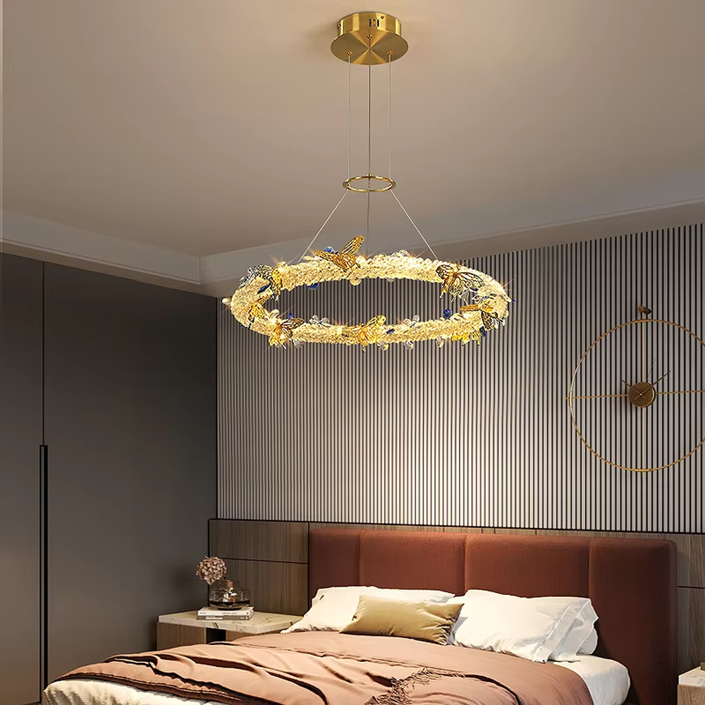 A light luxury and glamorous three-tiered ring chandelier, decorated with crystal gravel, natural blue-veined stone, and gold metal butterflies. Its staggered ring structure resembles flowing cosmic orbits, emitting a brilliant yet soft glow when lit, combining artistic decoration with lighting functionality, ideal for creating a high-end and romantic space atmosphere.