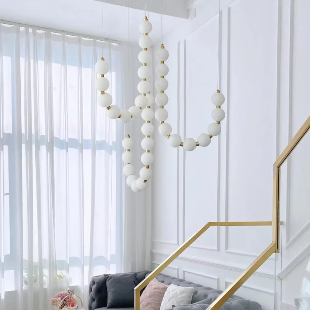 Modern Light Luxury Curved Beaded Chandelier, Milk white spherical lamps connected in a wave shape with gold metal details, serves both lighting and decorative purposes, ideal for duplex stairwells, high-ceiling living rooms, villas and other high-ceiling spaces.

