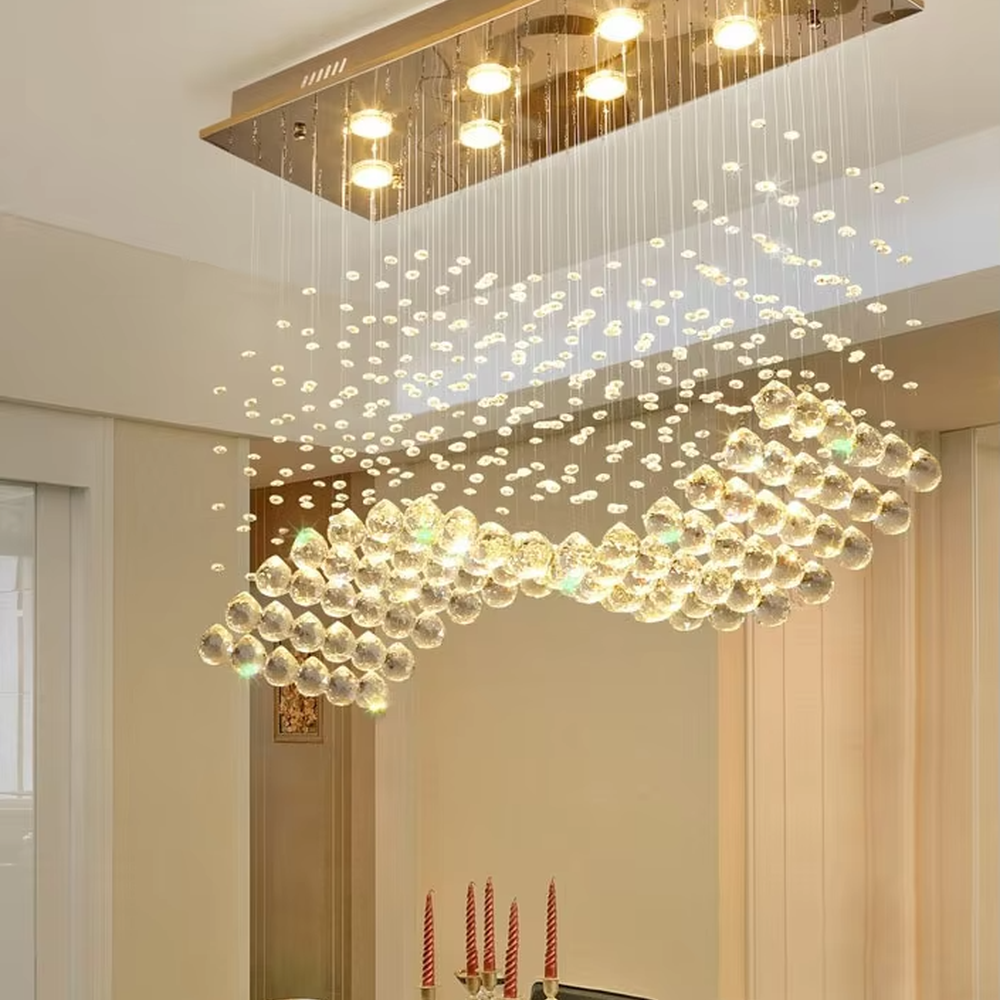 This modern light luxury rectangular crystal ceiling lamp is composed of a large number of hanging crystal bead strings, presenting a layered waterfall shape. The light refracts through the crystal to emit a brilliant and transparent glow, serving both core lighting and decorative purposes, suitable for modern light luxury style spaces such as living rooms and dining rooms.