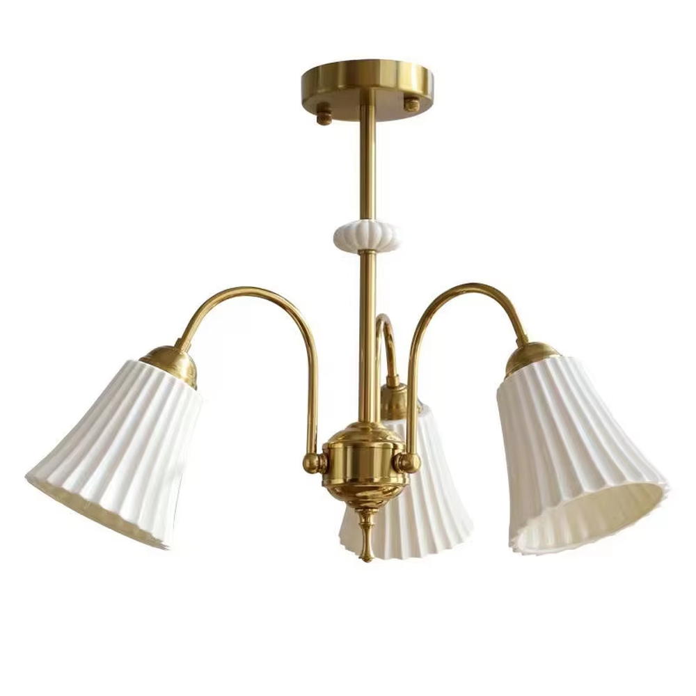 A French retro light luxury style 3-head chandelier, featuring a brass-colored metal frame paired with pleated fabric lampshades. It emits a soft and warm glow when lit, combining decorative appeal with practical illumination, ideal for creating an elegant and romantic space atmosphere.