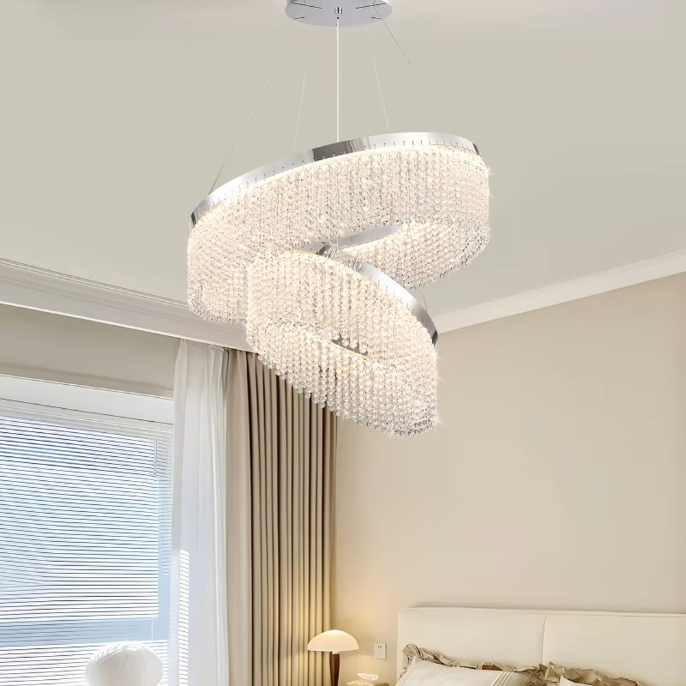 Modern light luxury double-ring spiral crystal chandelier, composed of dense crystal particles and a silver metal frame, presenting a flowing spiral shape. It emits brilliant and soft light, combining artistic decorativeness and lighting function, suitable for core lighting and atmosphere creation in living rooms, dining rooms, villa high-ceiling spaces, etc.