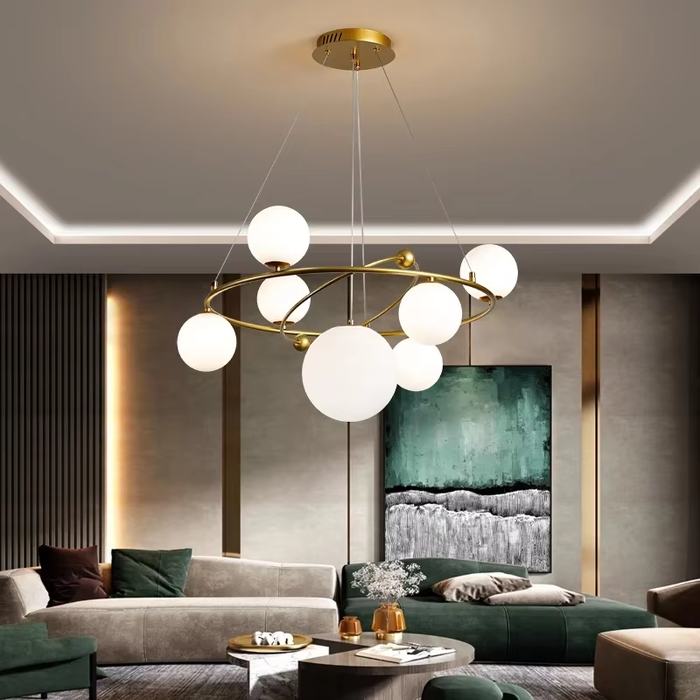 A modern light luxury style planetary orbit chandelier, featuring a gold metal ring frame paired with milky white glass glowing spheres, shaped like planets orbiting a star. It emits a soft and uniform glow when lit, combining decorative appeal with practical illumination, ideal for creating a minimalist and sophisticated space atmosphere.