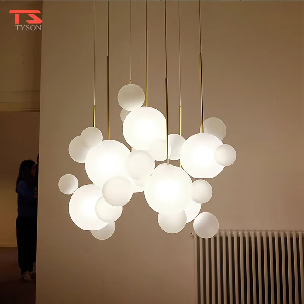 A modern dreamy cloud bubble chandelier, composed of multiple frosted glass balls of varying sizes paired with gold suspension rods. It emits soft and even light when lit, combining decorative appeal with practical illumination, ideal for creating a romantic and soothing space atmosphere.