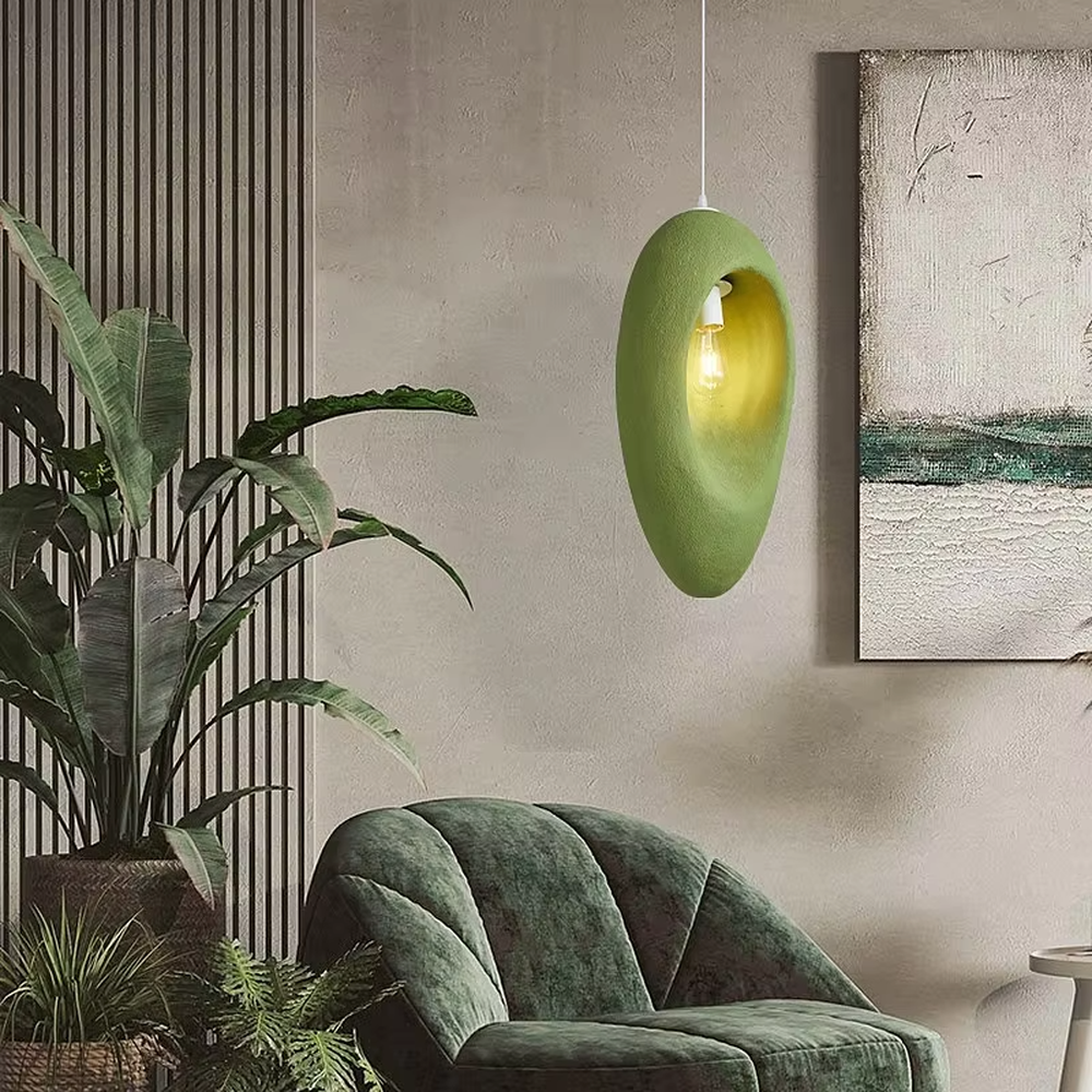 This is a modern wabi-sabi style pebble-shaped pendant lamp, made of frosted cement/resin material with a semi-embedded lighting design, available in colors like gray and green, which has both lighting and decorative functions, suitable for modern minimalist, wabi-sabi style bedrooms, entrances, cafes and other spaces.
