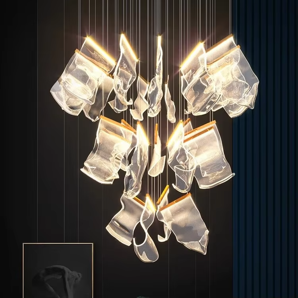 A modern light luxury style layered art chandelier, featuring irregularly folded transparent glass panels suspended by thin wires, with gold trim on the edges. It emits a soft and transparent glow when lit, combining decorative appeal with practical illumination, ideal for creating a high-end and dreamy space atmosphere.
