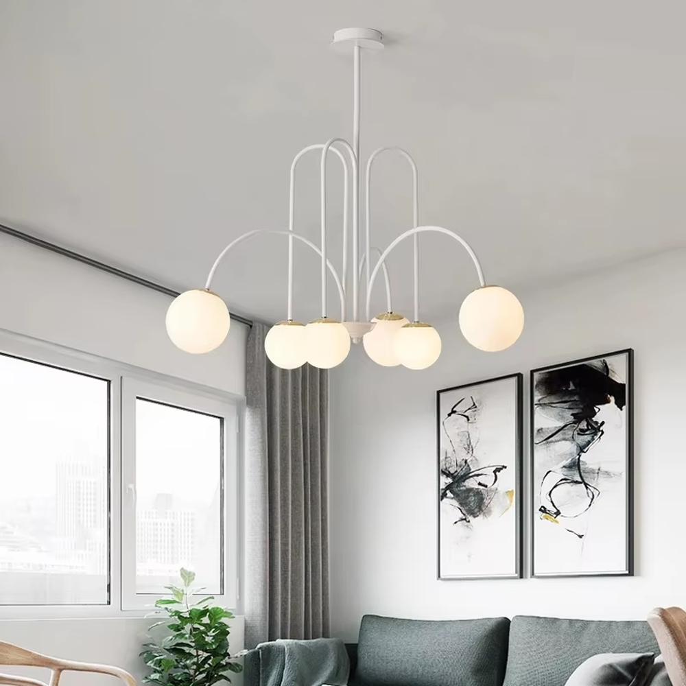 A multi-head chandelier combining modern light luxury and French retro styles, featuring a gold metal curved branch frame paired with milky white glass glowing spheres of varying sizes. It emits soft and uniform warm light when lit, combining decorative appeal with practical illumination, ideal for creating an elegant and dynamic space atmosphere.