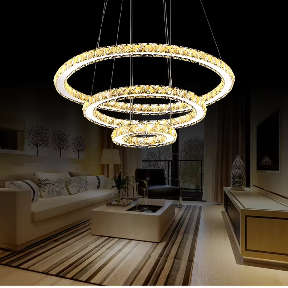 This light luxury black-gold interlaced ring crystal chandelier features a multi-layer flowing ring shape made of metal frames and crystal strips, with light refracting a brilliant halo through the crystals, serving both lighting and decorative purposes, suitable for modern light luxury spaces such as living rooms and dining rooms.
