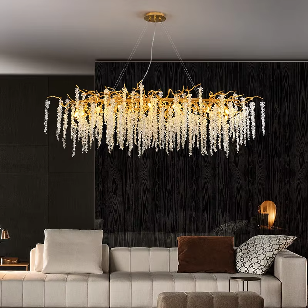 This is a light luxury art-style branch-shaped crystal chandelier, with a gold metal branch frame paired with densely hanging crystal pendants, presenting a dynamic flower cluster blooming effect, with both decorative and lighting functions, ideal for high-end indoor spaces such as living rooms and dining rooms.