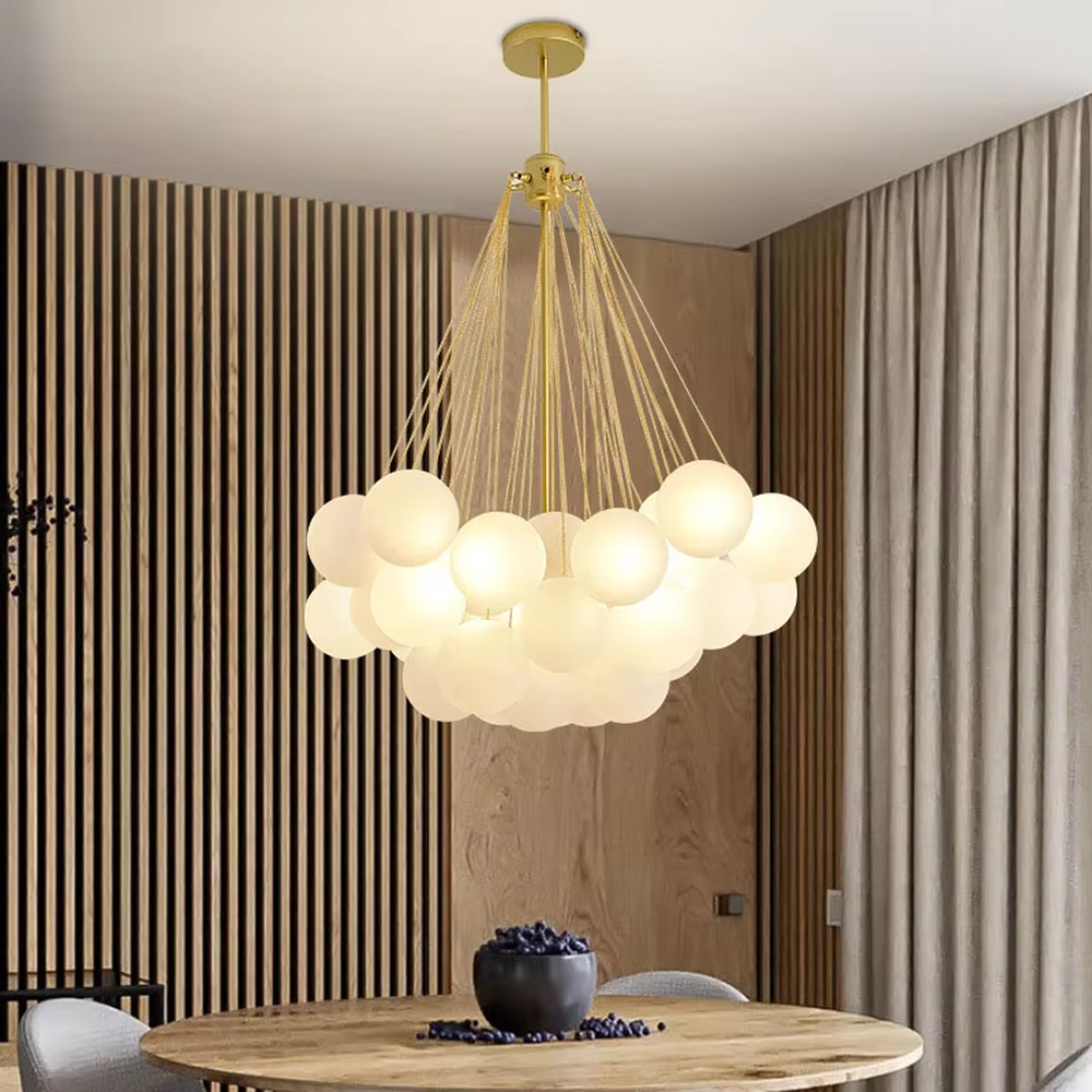 Modern light luxury cloud-shaped chandelier, with a golden metal frame and milky white glass ball lampshades stacked into a full cloud shape, featuring soft and warm light, combining decorative and lighting functions, suitable for living rooms, dining rooms, bedrooms and other modern style spaces.