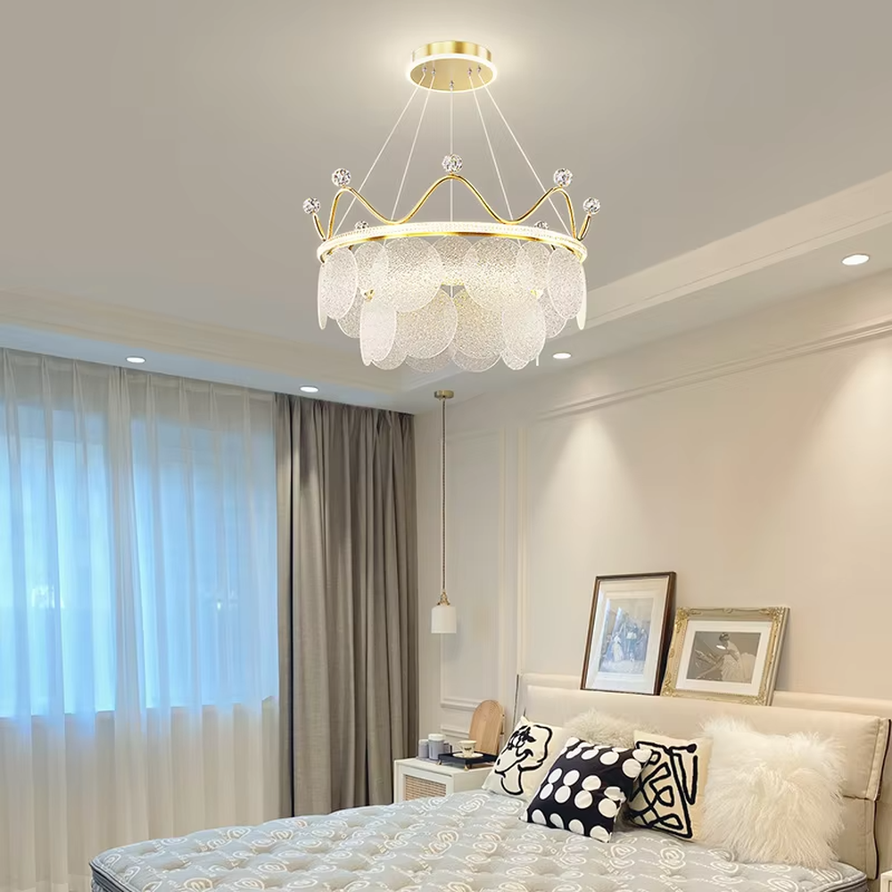 A light luxury princess-style crown-shaped chandelier, featuring a gold metal crown frame paired with crystal decorations and glowing glass lampshades. It emits a brilliant yet soft glow when lit, combining decorative appeal with practical illumination, ideal for creating a romantic and dreamy space atmosphere.