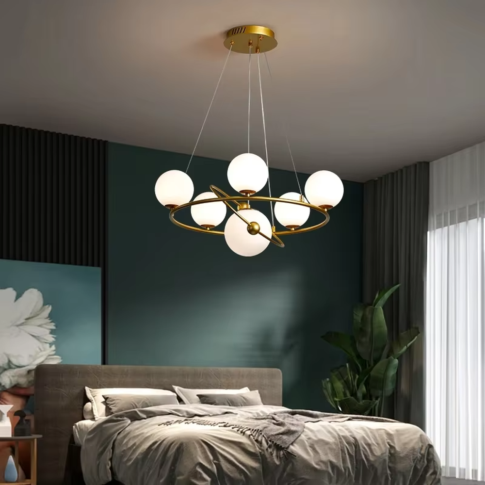 A modern light luxury style planetary orbit chandelier, featuring a gold metal ring frame paired with milky white glass glowing spheres, shaped like planets orbiting a star. It emits a soft and uniform glow when lit, combining decorative appeal with practical illumination, ideal for creating a minimalist and sophisticated space atmosphere.