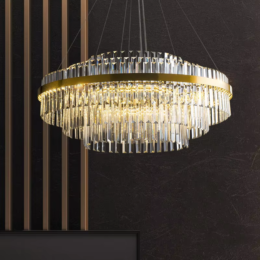 A modern light luxury style circular double-layer crystal chandelier, featuring a gold metal frame paired with multiple layers of long cut crystal strips. It emits a brilliant and soft glow when lit, combining decorative appeal with practical illumination, ideal for creating a luxurious and high-end space atmosphere.