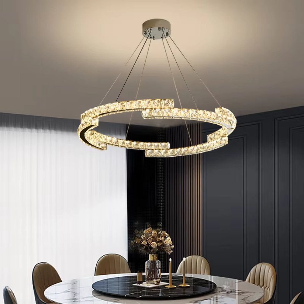 This light luxury interlaced ring crystal chandelier features a multi-layer flowing ring shape made of metal frames and crystal strips, with light refracting a brilliant halo through the crystals, serving both lighting and decorative purposes, suitable for modern light luxury spaces such as living rooms and dining rooms.