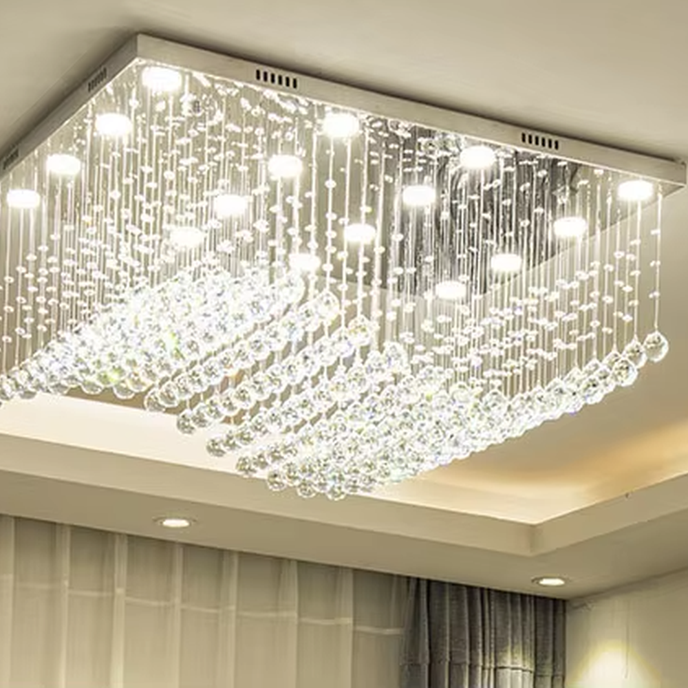 This modern light luxury rectangular crystal ceiling lamp is composed of a large number of hanging crystal bead strings, presenting a layered waterfall shape. The light refracts through the crystal to emit a brilliant and transparent glow, serving both core lighting and decorative purposes, suitable for modern light luxury style spaces such as living rooms and dining rooms.