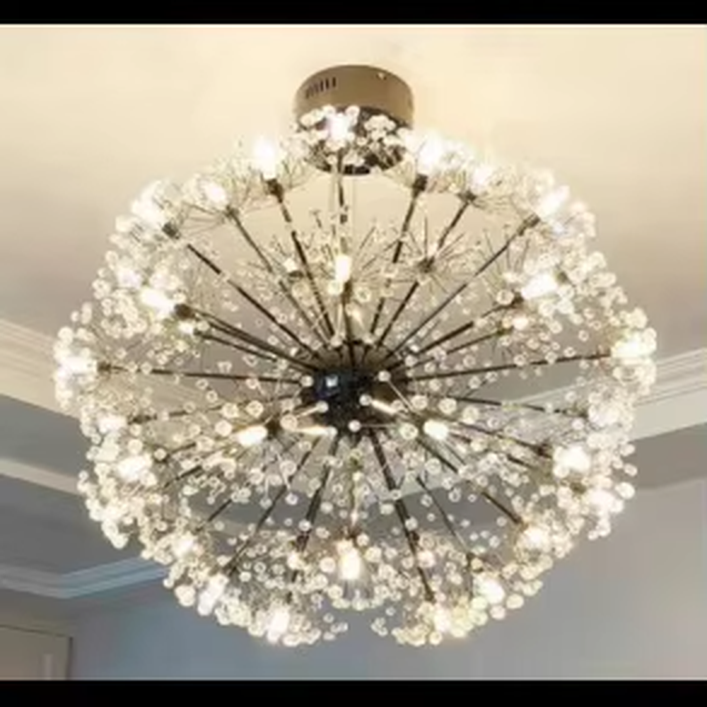This light luxury dandelion-shaped crystal chandelier features a spherical structure with metal arms and crystal ornaments, with light refracting a brilliant halo through the crystals, serving both lighting and decorative purposes, suitable for modern light luxury spaces such as living rooms and dining rooms.