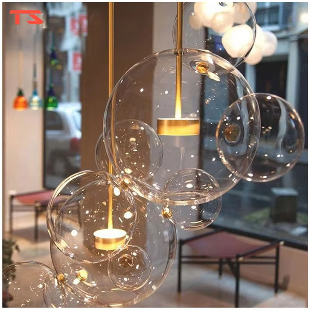 A modern light luxury style bubble-shaped chandelier, suspended by gold wires, paired with transparent glass bubble lampshades of varying sizes. It emits a soft and transparent glow when lit, combining decorative appeal with practical illumination, ideal for creating a dreamy and light space atmosphere.
