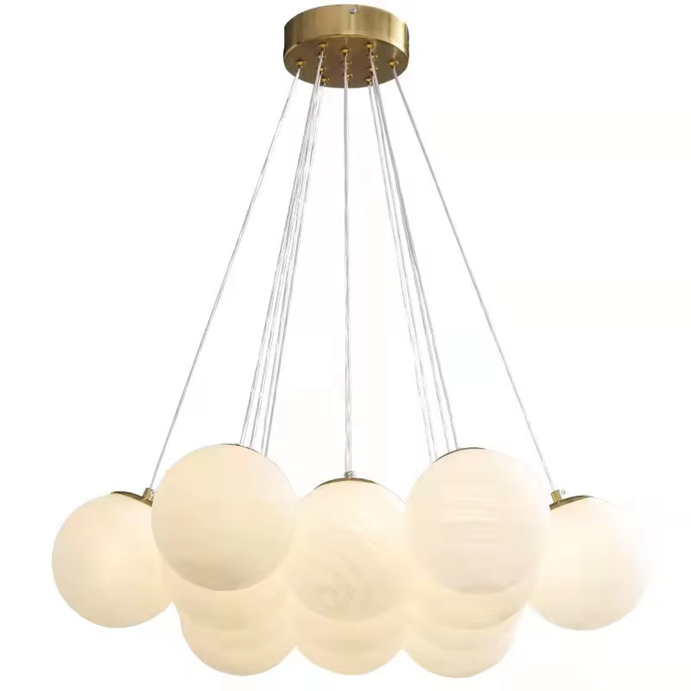 French light luxury cloud cluster milk white ball chandelier, with a golden metal base paired with transparent suspension wires and milky white spherical lampshades, shaped like a cluster of fluffy clouds, featuring soft and warm light, combining decorative and lighting functions, suitable for bedrooms, princess rooms, homestay guest rooms and other soft style spaces.