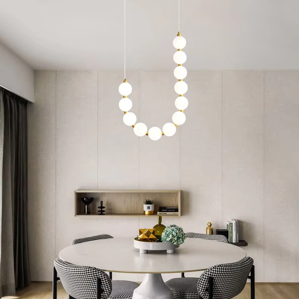 Modern Light Luxury Curved Beaded Chandelier, Milk white spherical lamps connected in a wave shape with gold metal details, serves both lighting and decorative purposes, ideal for duplex stairwells, high-ceiling living rooms, villas and other high-ceiling spaces.
