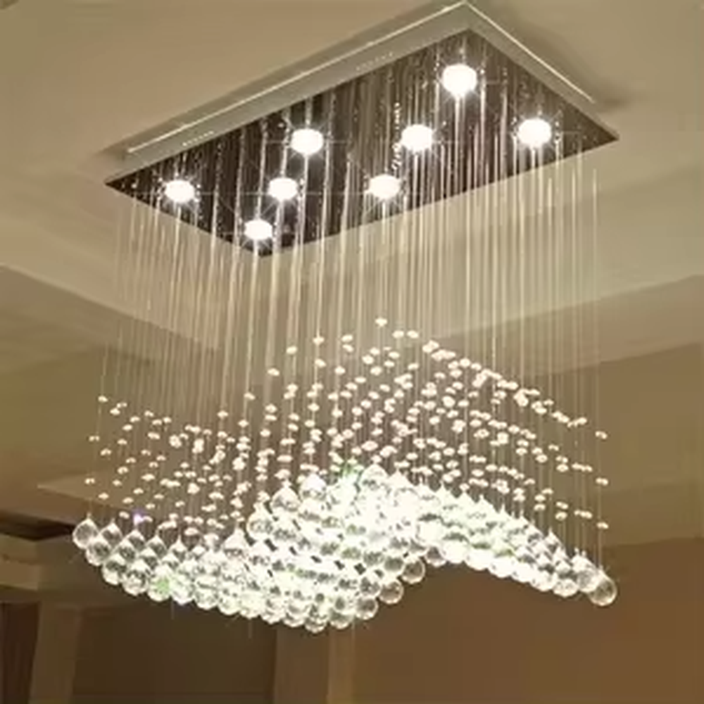 This modern light luxury rectangular crystal ceiling lamp is composed of a large number of hanging crystal bead strings, presenting a layered waterfall shape. The light refracts through the crystal to emit a brilliant and transparent glow, serving both core lighting and decorative purposes, suitable for modern light luxury style spaces such as living rooms and dining rooms.