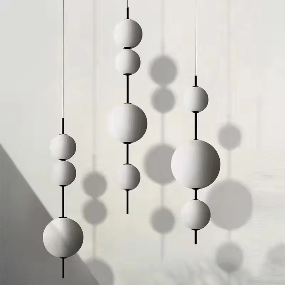 Modern minimalist black-and-white hanging spherical chandelier, with black metal rods paired with milk-white frosted glass ball lampshades of different sizes, shaped like staggered interstellar molecules, featuring soft and uniform light, combining decorative and lighting functions, suitable for dining rooms, bars, commercial spaces and other modern style scenarios.