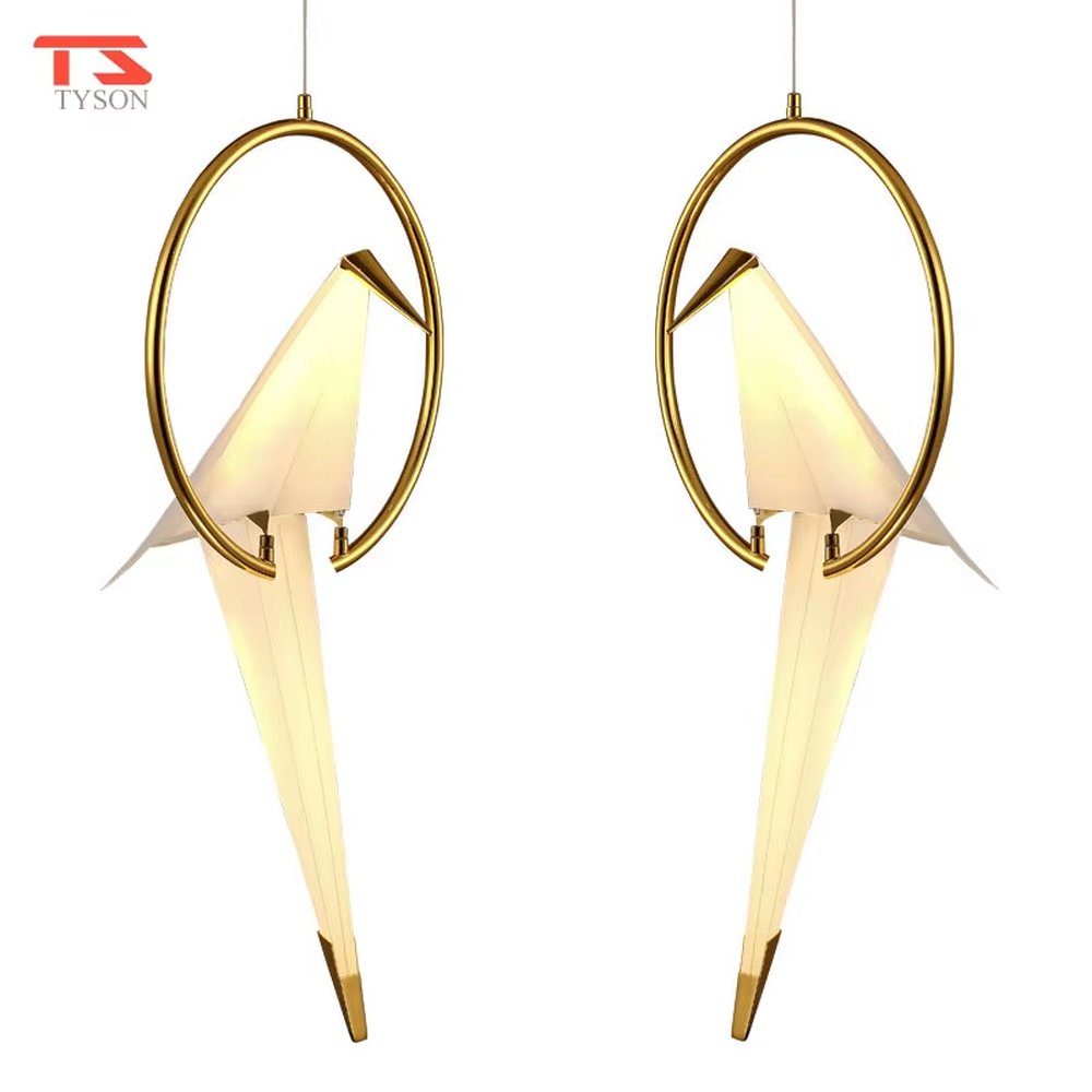 A modern art light luxury style origami crane chandelier, featuring a gold metal ring frame paired with an origami-style white translucent lampshade, shaped like an origami crane perched in a gold ring. It emits a soft and warm glow when lit, combining decorative appeal with practical illumination, ideal for creating an elegant and soothing space atmosphere.