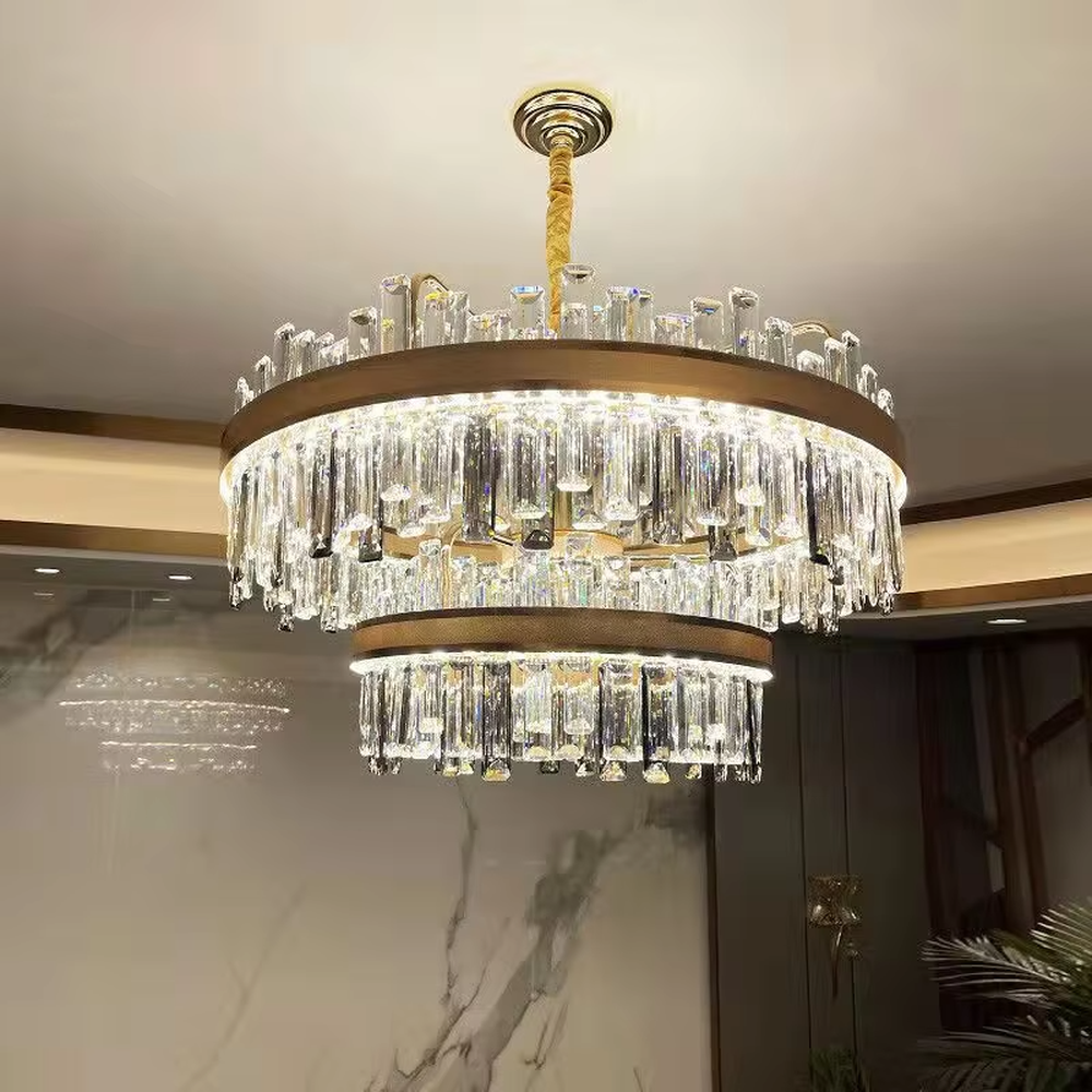 Modern light luxury double-layer ring crystal chandelier, with a golden metal frame and layered transparent crystal strips hanging down, featuring bright and soft light, combining decorative and lighting functions, suitable for living rooms, dining rooms, villas and other light luxury style spaces.
