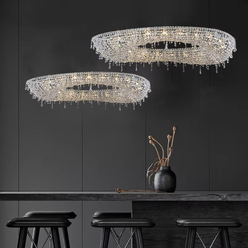 Modern art double-ring streamlined crystal chandelier, with dense crystal particles forming a flowing cloud pattern with staggered double rings, emitting brilliant and transparent light, combining artistic decorativeness and lighting function, suitable for core lighting and atmosphere creation in large spaces such as high-ceiling living rooms, villa hollow areas, and high-end clubs.