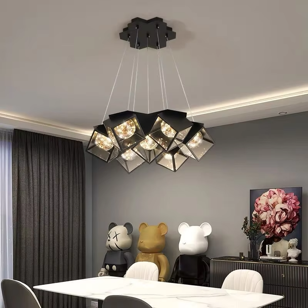 A modern industrial style cluster chandelier, featuring a black metal geometric cube structure with mirrored transparent panels and vintage filament bulbs. Its staggered, interlocking design is highly distinctive, combining decorative appeal with practical illumination, ideal for creating a bold and avant-garde space atmosphere.