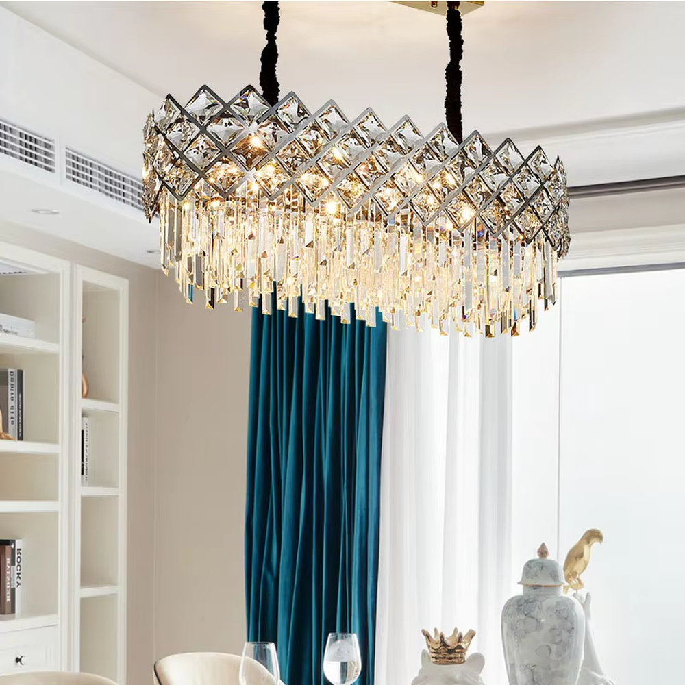 This light luxury rectangular crystal chandelier features a metal frame paired with a rhombus-faceted crystal border and drooping crystal tassels, with light refracting a brilliant halo through the crystals, serving both lighting and decorative purposes, suitable for modern light luxury spaces such as dining rooms and living rooms.
