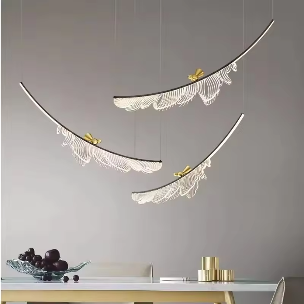 This is a light luxury art-style feather-shaped chandelier, with a black curved metal frame supporting a white light-transmitting feather-shaped lamp body, accented with gold decorations, presenting a dynamic and elegant visual effect, with both decorative and lighting functions, ideal for high-end indoor spaces such as dining rooms and living rooms.