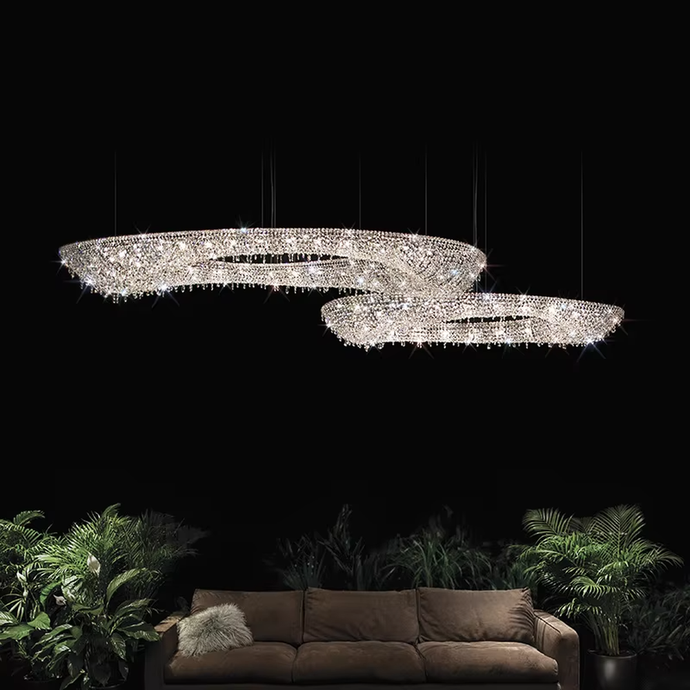 Modern art double-ring streamlined crystal chandelier, with dense crystal particles forming a flowing cloud pattern with staggered double rings, emitting brilliant and transparent light, combining artistic decorativeness and lighting function, suitable for core lighting and atmosphere creation in large spaces such as high-ceiling living rooms, villa hollow areas, and high-end clubs.