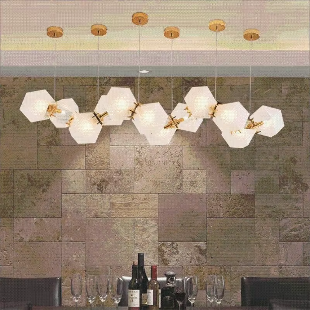 A modern light luxury style wave-shaped linear chandelier, suspended by gold wires, paired with frosted geometric polyhedral lampshades. It emits a soft and warm glow when lit, combining decorative appeal with practical illumination, ideal for creating an exquisite and high-end space atmosphere.