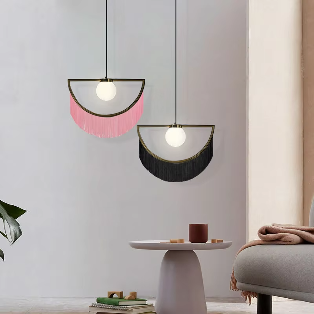Modern minimalist semicircular tassel pendant lamp, with black-gold/pink-gold metal semicircular frames paired with semi-transparent lampshades, cascading same-color tassel decorations, built-in spherical light sources, emitting soft and warm light, combining decorativeness and lighting function, suitable for accent lighting and atmosphere creation in spaces such as bedroom nightstands, restaurant bars, and children's rooms.