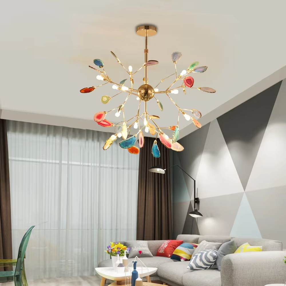 A modern art style linear chandelier, featuring a gold metal branch-like frame with suspended natural colorful agate slices. It emits soft and vibrant light when lit, combining artistic decoration with lighting functionality, ideal for creating a romantic and lively space atmosphere.
