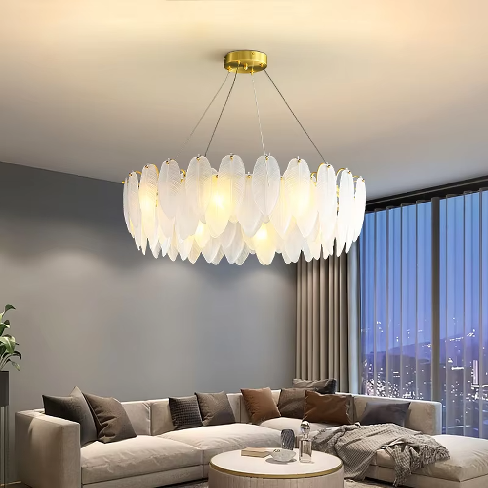 A modern light luxury style ring chandelier, featuring a gold metal frame paired with double-layer feather-shaped gradient glass panels. It emits a soft and warm glow when lit, combining decorative appeal with practical illumination, ideal for creating a romantic and elegant space atmosphere.
