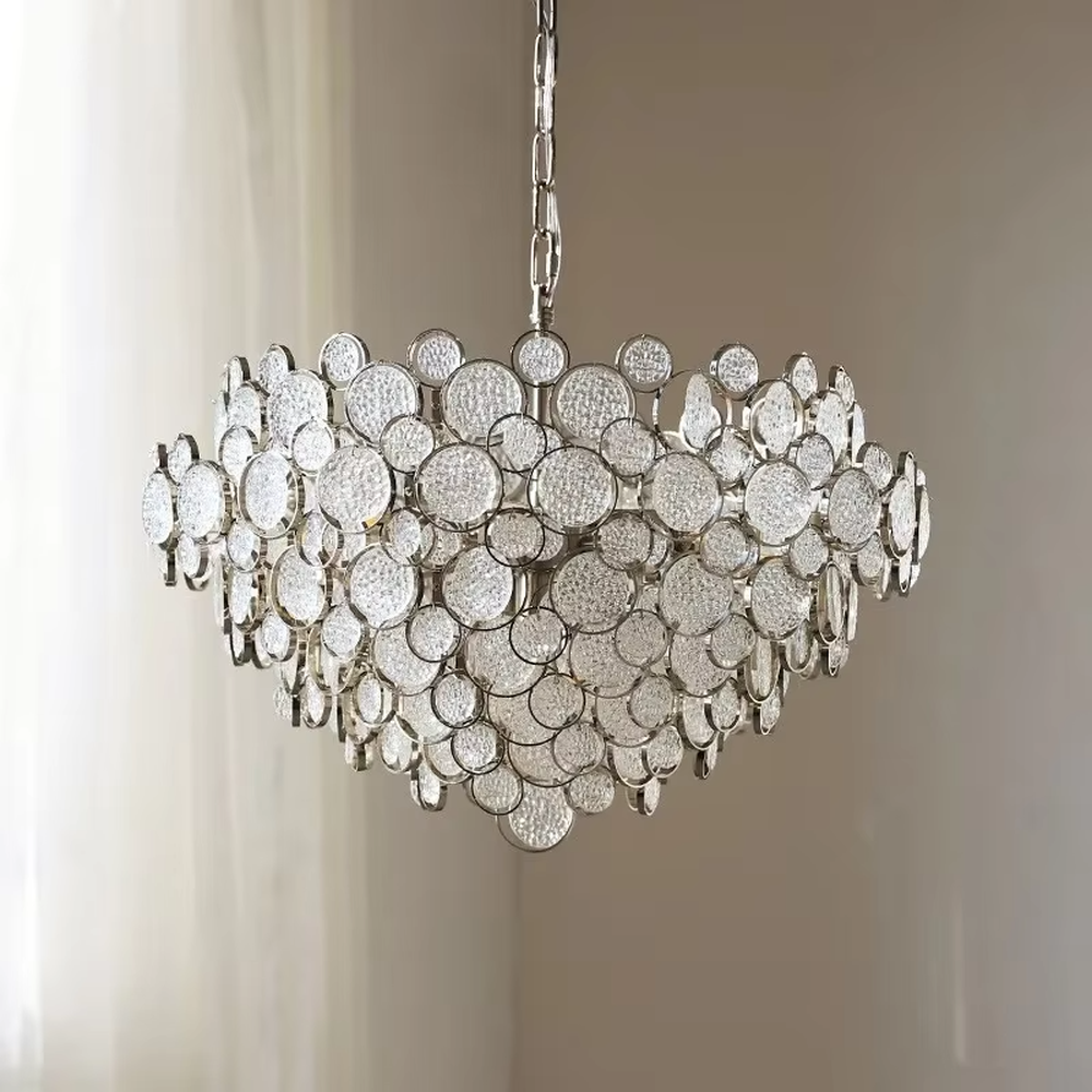 This light luxury silver diamond cloud chandelier is composed of a large number of layered silver metal discs with diamond-like texture, presenting a fluffy and light cloud shape. Light refracts through the discs to emit a brilliant and soft halo, serving both lighting and decorative purposes, suitable for modern light luxury spaces such as living rooms and dining rooms.