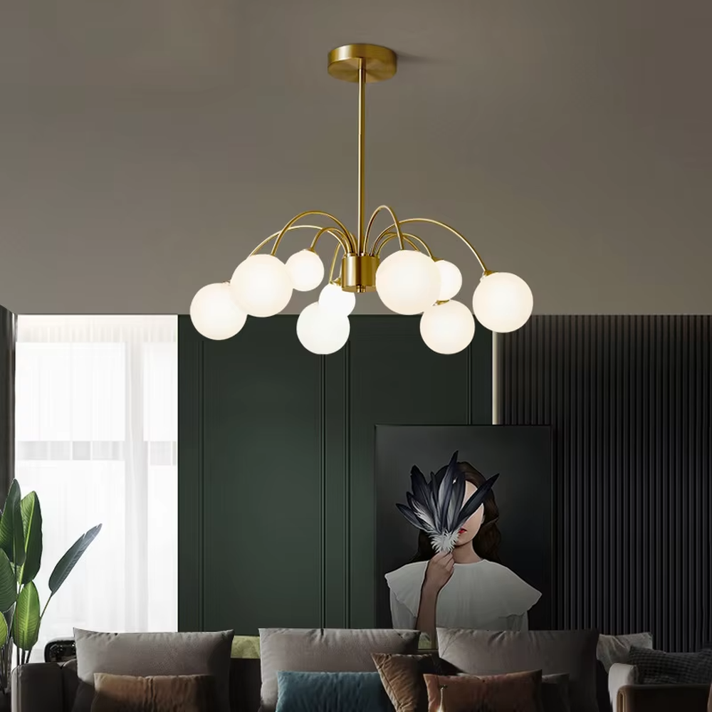 A modern light luxury style firefly chandelier, featuring a gold metal curved branch frame paired with multiple milky white glass glowing spheres of varying sizes, shaped like a blooming dandelion or flying fireflies. It emits a soft and uniform glow when lit, combining decorative appeal with practical illumination, ideal for creating a romantic and dynamic space atmosphere.