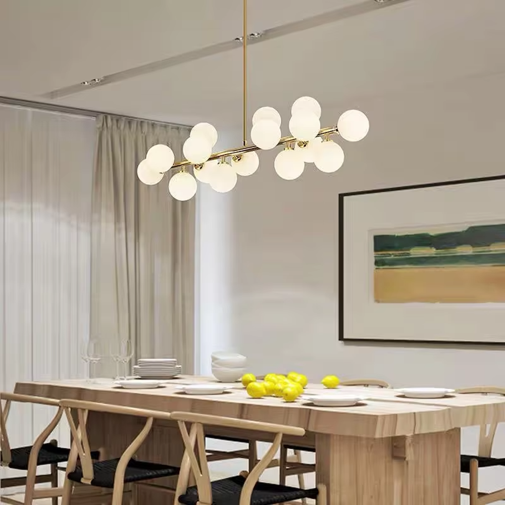 A modern light luxury style linear molecular ball chandelier, featuring a gold metal frame paired with multiple milky white glass glowing spheres of varying sizes, shaped like a star cluster or molecular structure suspended in space. It emits a soft and uniform glow when lit, combining decorative appeal with practical illumination, ideal for creating a minimalist and sophisticated space atmosphere.