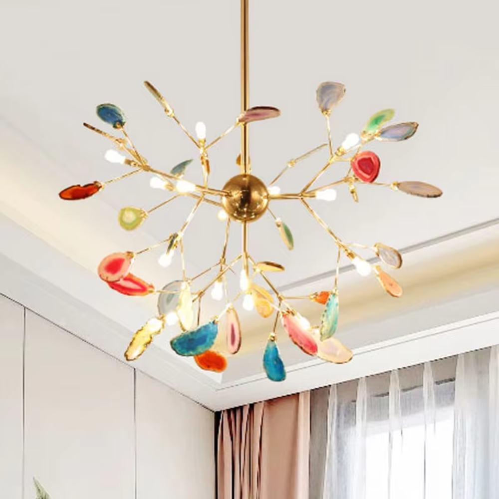 A modern art style linear chandelier, featuring a gold metal branch-like frame with suspended natural colorful agate slices. It emits soft and vibrant light when lit, combining artistic decoration with lighting functionality, ideal for creating a romantic and lively space atmosphere.
