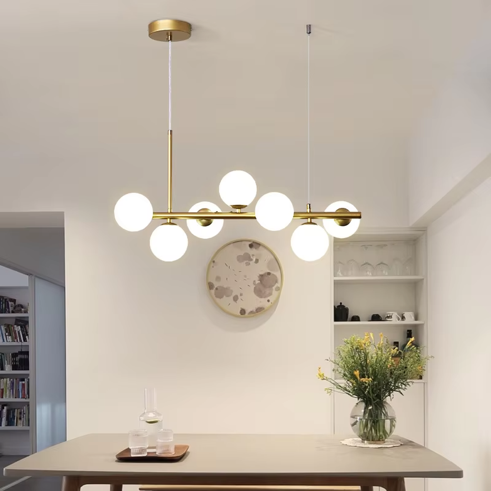 Modern minimalist long strip molecular ball chandelier, with a black and gold metal long rod and milky white glass ball lampshades, featuring a flexible and lightweight linear molecular structure, soft and uniform light, combining decorative and lighting functions, suitable for dining rooms, bars, living rooms and other modern style spaces.